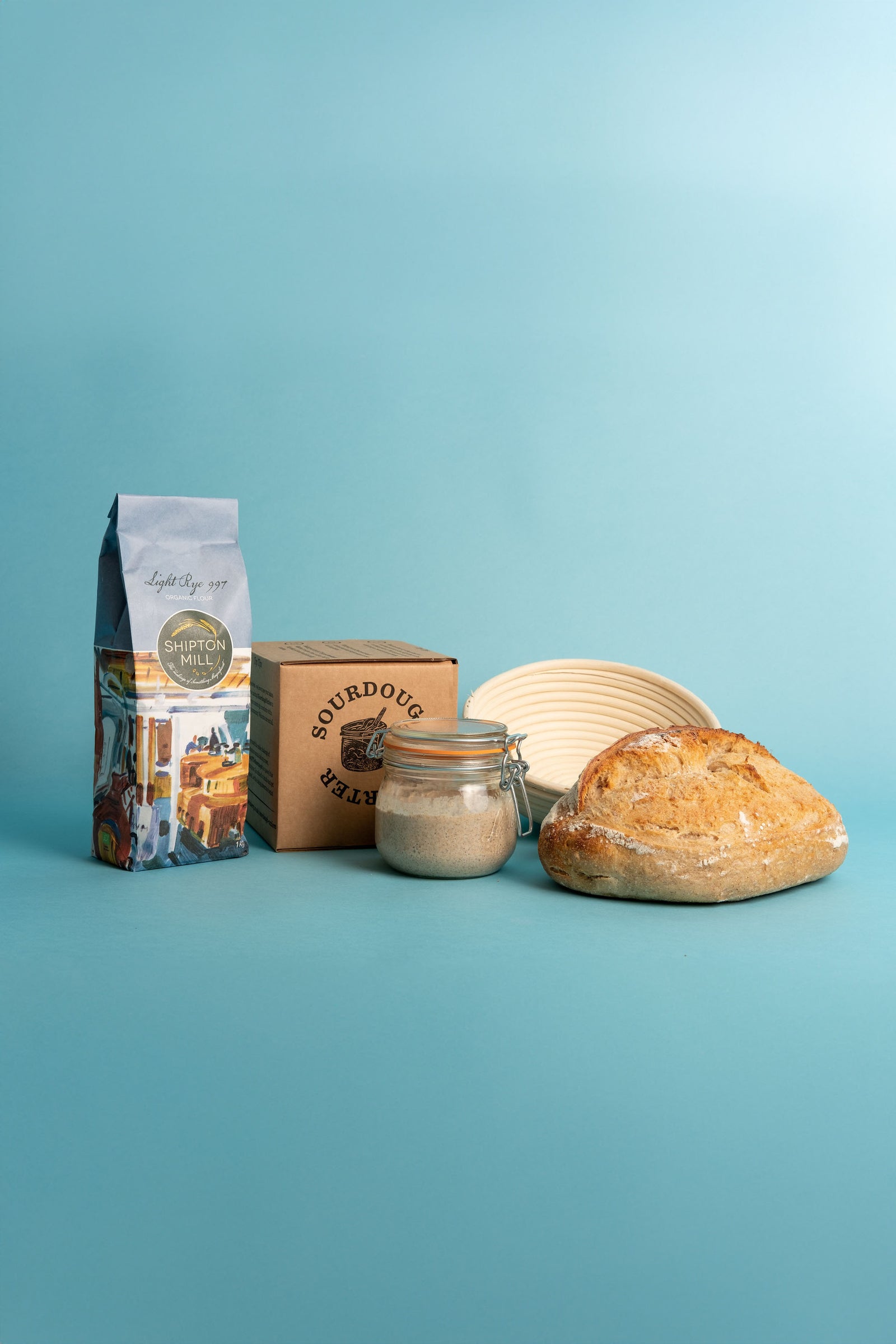 Flour, Sourdough Starter, Round Proving Basket and Sourdough Loaf